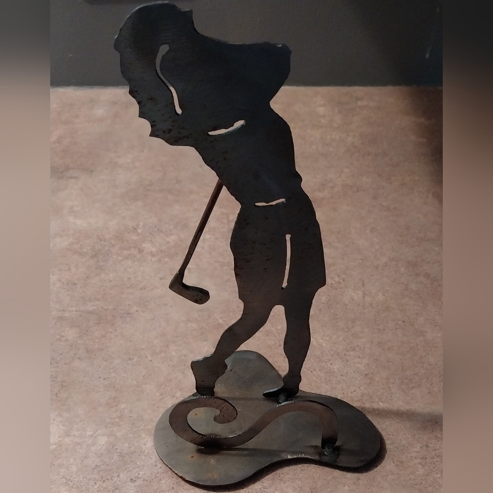 Scrap metal welded art figurine of a lady golfer.